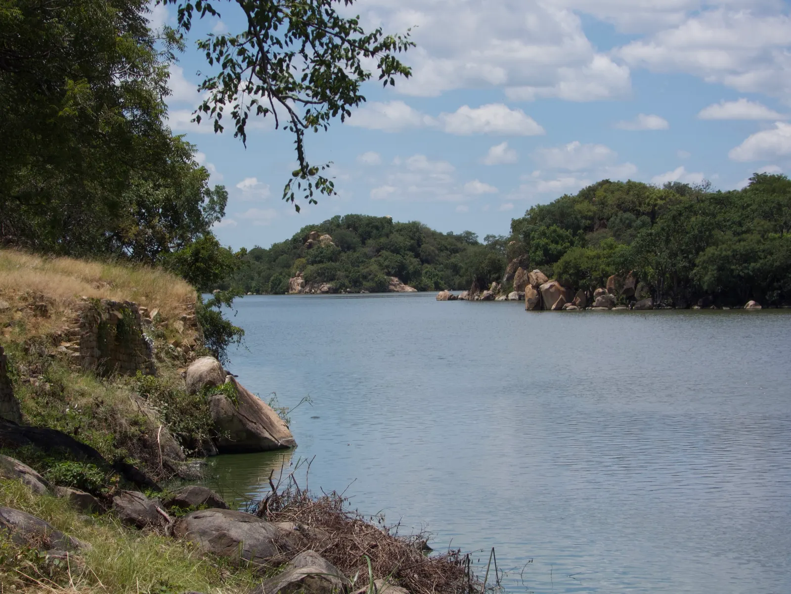 A dam at Khami in the green season, trees in full leaf