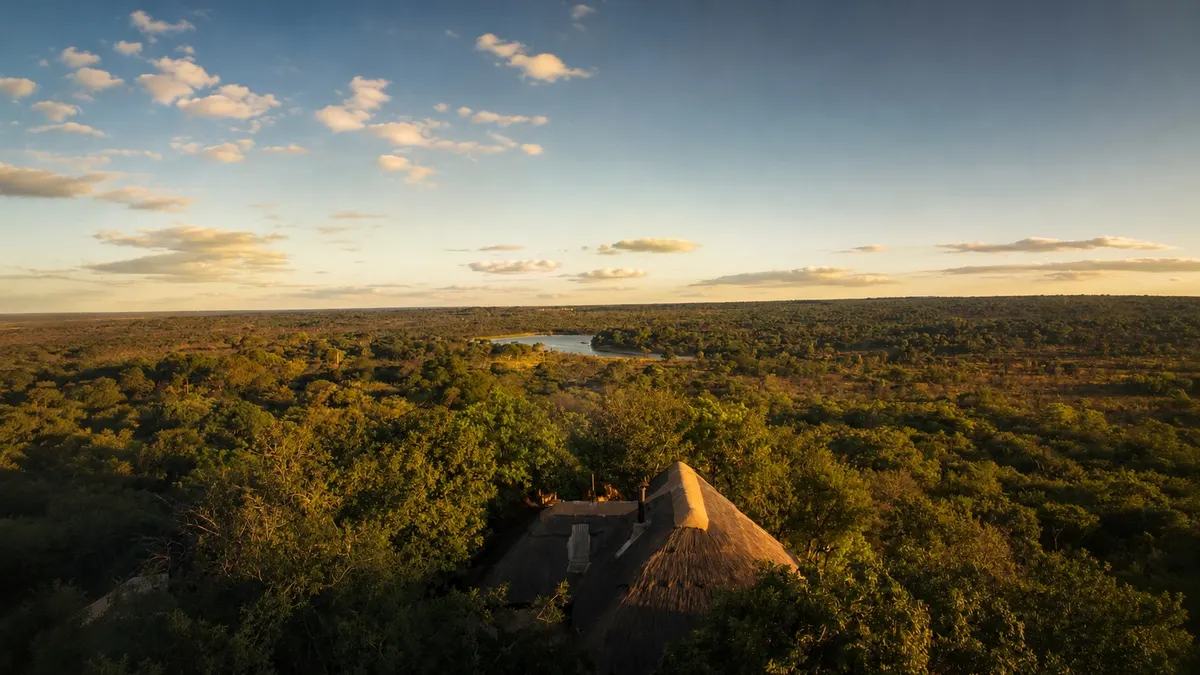 Khami Lodge at dusk from the air, the dam catching the last light
