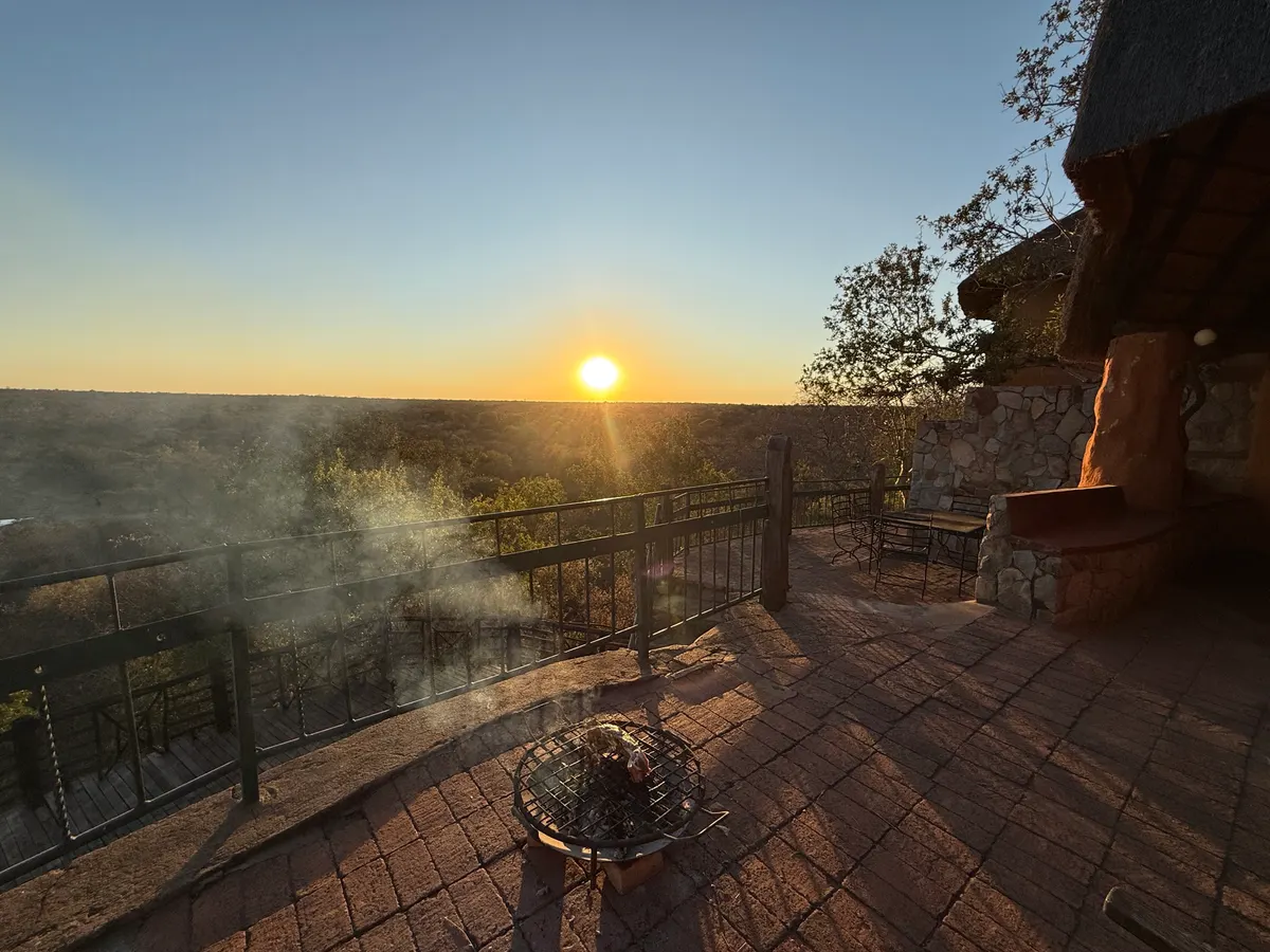 The boma fireplace at sunset, the reserve fading into the distance